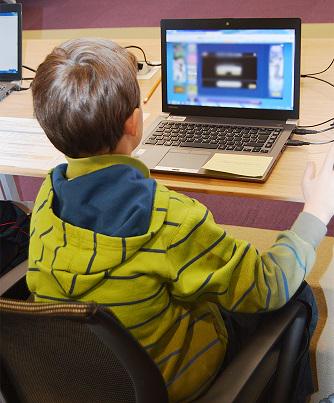 Boy at computer.