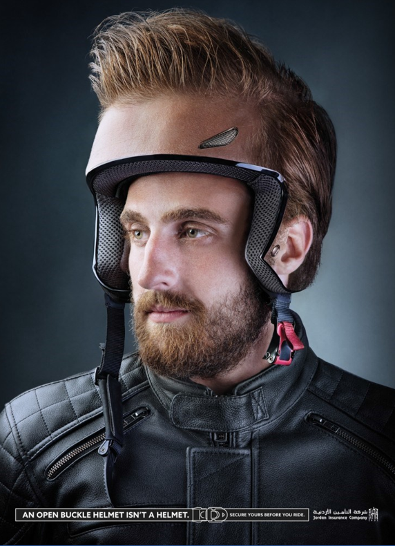 Man wearing skin-toned motorcycle helmet with text: “An open bucklet helmet isn’t a helmet