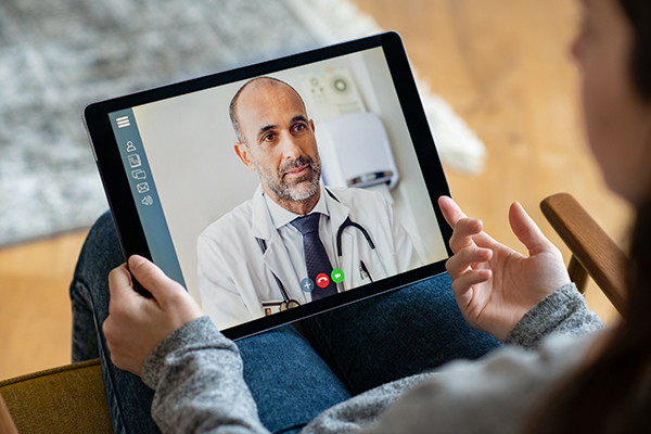 Someone on a video call with a doctor