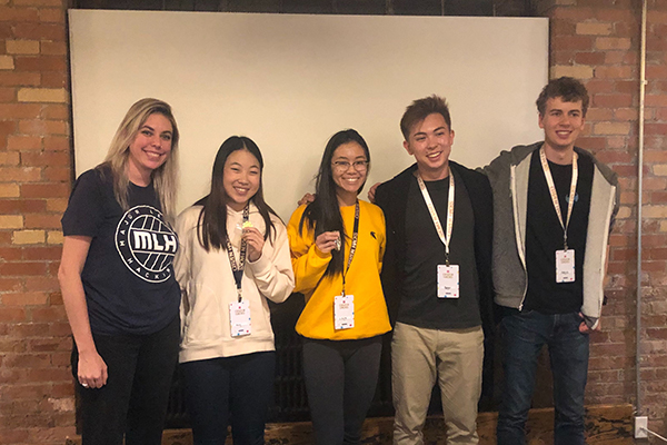 Winners Anne Chungand Lena Nguyen (second from left and middle) pose with Paige L., a Major League Hacking representative (left), and event organizers Benn McGregor (second from right) and Marcel O’Neil (right).