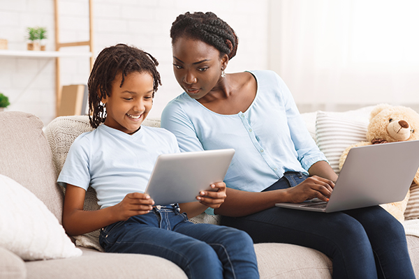 Mother and daughter looking at something online.