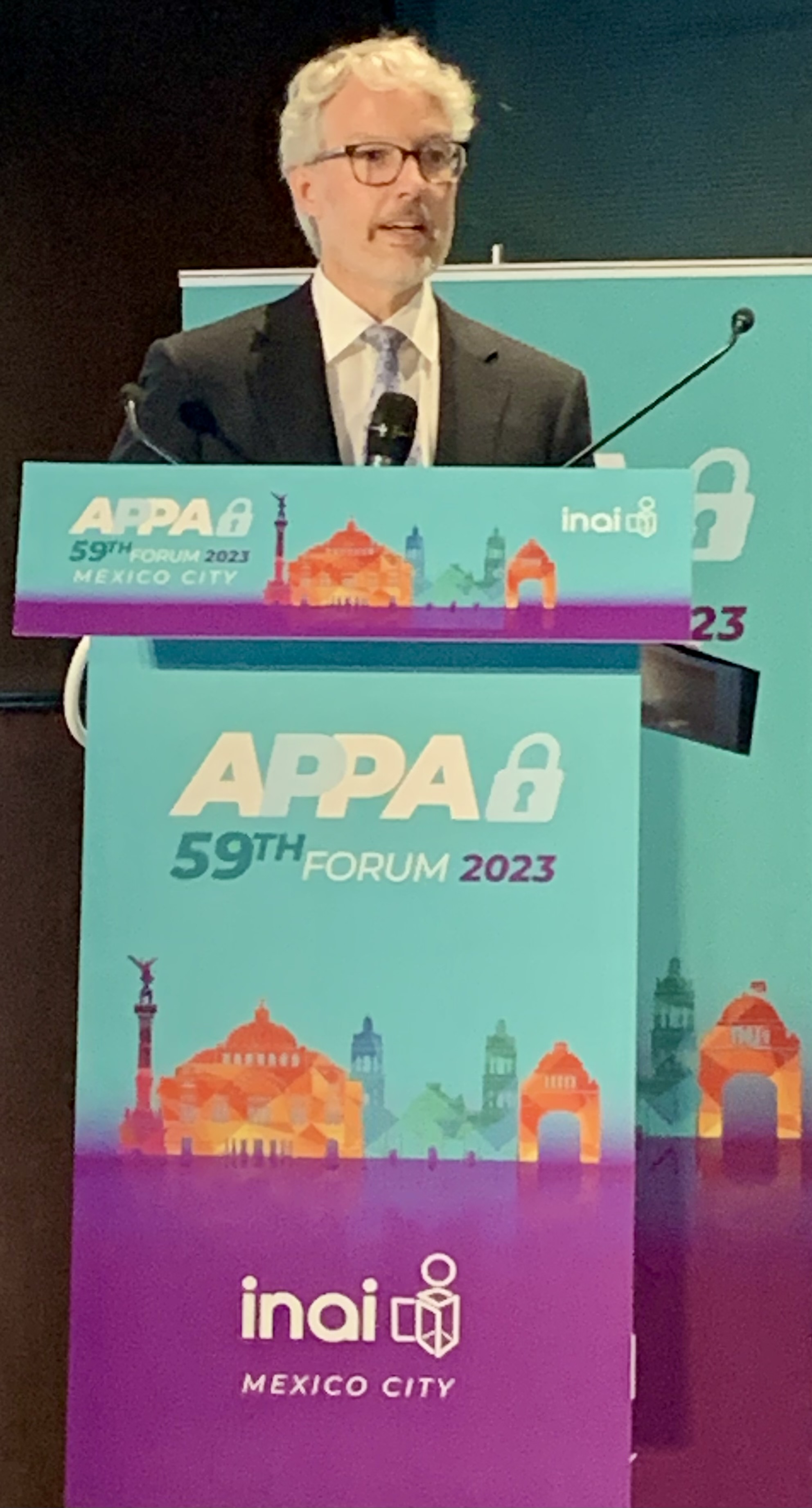 Privacy Commissioner of Canada Philippe Dufresne stands behind a podium to addresses delegates to the Asia Pacific Privacy Authorities (APPA) Forum in Mexico City.