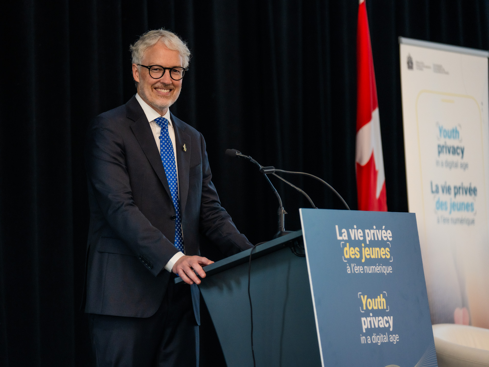 Privacy Commissioner of Canada Philippe Dufresne speaking at the podium